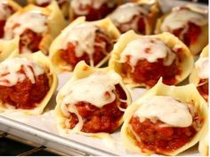 stuffed shells filled with meat and sauce on top of a baking sheet in an oven