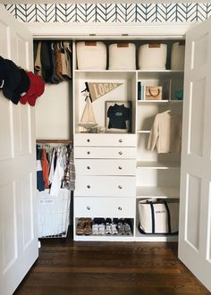 an open closet with clothes and shoes in it