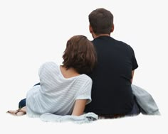 a man and woman sitting on the ground looking at something in the distance with their back to them