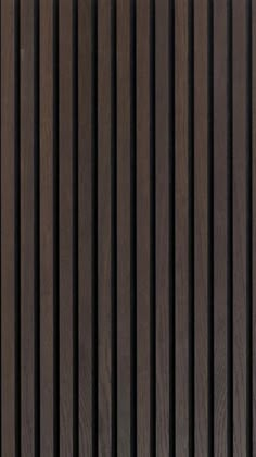 the side of a wooden wall with vertical slats in brown and black woodgrain