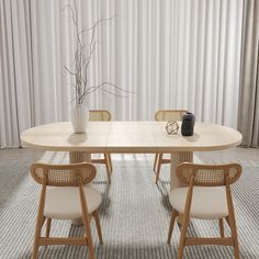 a dining table with two chairs and a vase on the top, in front of a curtained wall