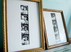 two framed pictures sitting next to each other on top of a shelf in front of a wall