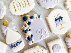 decorated cookies with white frosting and gold accents for a 30th birthday cake topper