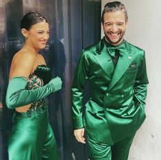 a man and woman dressed in green standing next to each other