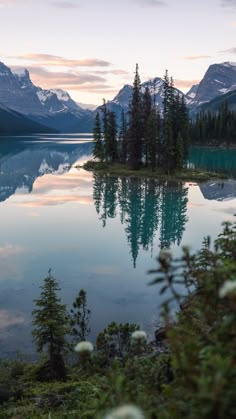 a lake surrounded by mountains and trees