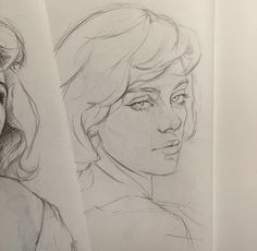 two drawings of women's faces on paper