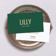 two business cards sitting on top of a plate