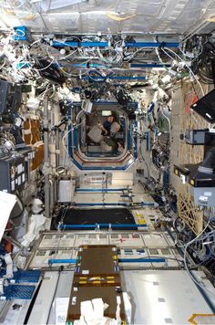 the inside of a space station with many electronics and equipment on it's walls