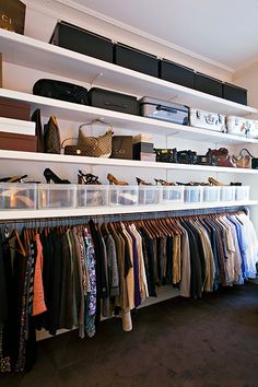 an image of a closet with clothes on the shelves and other items hanging from it