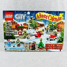 the lego city christmas calendar is displayed on a white tableclothed surface, with an image of santa's sleigh and his reindeer