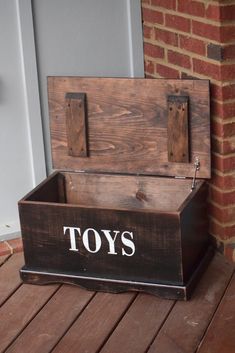 a wooden toy chest sitting on top of a porch