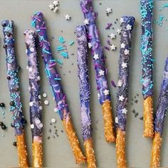 purple and blue decorated sticks with sprinkles on them