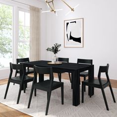 a black table and chairs in a white room