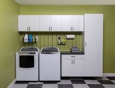 a washer and dryer in a room with green walls