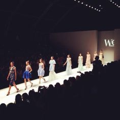 several models walking down the runway at a fashion show