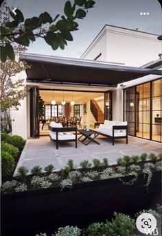 an outdoor living area with furniture and plants