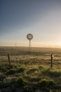 a windmill in the middle of an open field