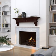 a living room filled with furniture and a fire place in the middle of a fireplace