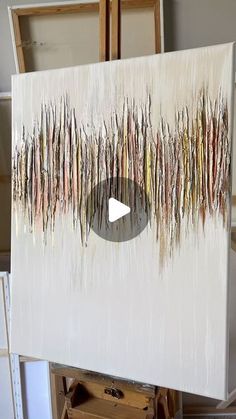 a painting is being displayed on a easel