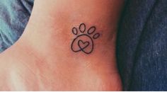 a small paw and heart tattoo on the ankle