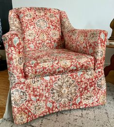 a red and white chair sitting on top of a rug