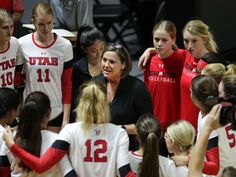 a coach talking to her team during a basketball game