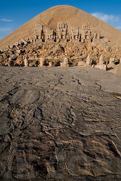 the desert is covered in rocks and sand, with an ancient structure on top of it