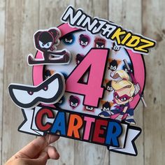 a person holding up a sticker with the number four in front of them and cartoon characters on it