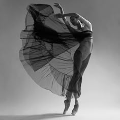 a ballerina in black and white poses for the camera