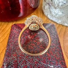 a diamond ring sitting on top of a red case