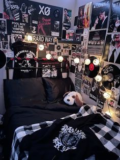 a bed room with a neatly made bed and lots of posters on the wall