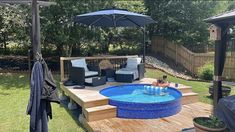 a small backyard with a pool and patio furniture