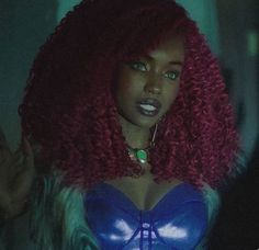 a woman with red hair wearing a blue bra