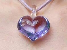 This exquisite Venetian lilac purple 3D glass heart pendant would make a perfect present. Due to its semi-translucent and reflective qualities, this beautiful pendant can display varying shades of lilac in different light conditions. Width: approximately 32mm Drop: approximately 40mm including glass bail The pendant is finished with approximately 90cm of lilac faux suede lace, adjustable to length desired.  Organza ribbon is also available in silver or white if preferred. Please specify at check Purple Double Heart Jewelry For Gifts, Purple Double Heart Jewelry Gift, Purple Heart Pendant Necklace For Jewelry Making, Valentine's Day Clear Glass Jewelry, Clear Heart Charm Necklace With Heart Pendant, Handmade Clear Heart Pendant Necklace, Handmade Clear Heart-shaped Jewelry, Purple Heart Pendant, Purple Gemstone Heart Pendant Jewelry