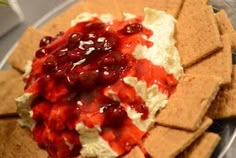 a plate with crackers and cranberry sauce on it