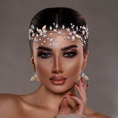 a woman wearing a tiara with flowers on it's head is posing for the camera