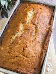 a loaf of banana bread sitting on top of a wooden cutting board