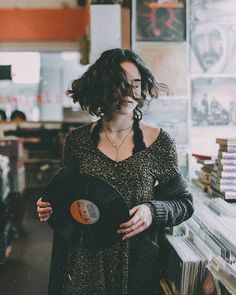 a woman holding a record in her hands