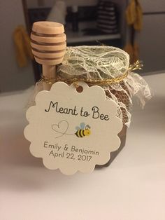 a honey jar with a label that says meant to bee on it and a wooden stick