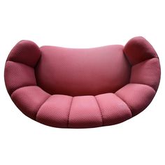 the pink chair is shaped like an oval cushion, and sits in front of a white background