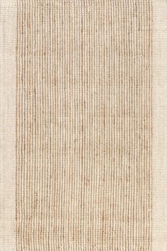 a beige and white rug with vertical stripes on the bottom, in an area that looks like it has been made out of grasscloth