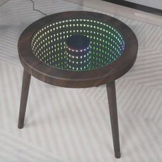 a coffee table with lights on it sitting on the floor in front of a window