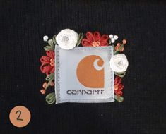 a close up of a piece of clothing with flowers on the front and back of it