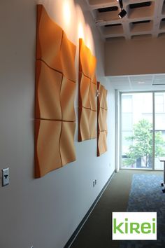 an office hallway with three orange panels on the wall