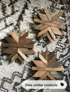 three wooden snowflakes sitting on top of a rug