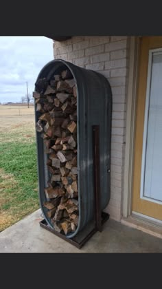 a large pile of firewood sitting in front of a building next to a door