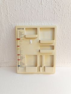 a white plastic shelf with several compartments on it