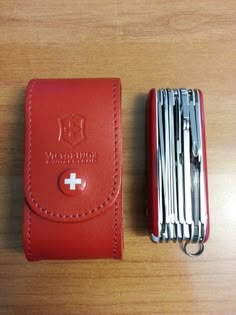 a swiss army knife and wallet sitting on a table