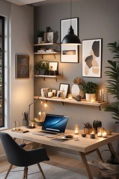 a laptop computer sitting on top of a wooden desk in front of a wall filled with pictures