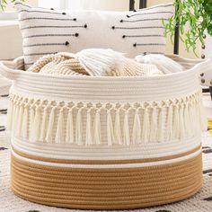 a large white and brown basket sitting on top of a rug